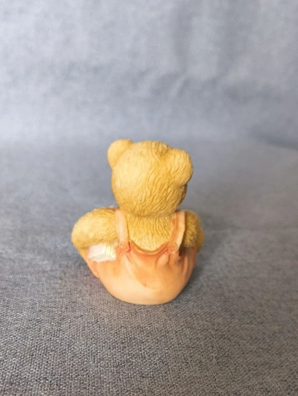 Cherished Teddies tan bear figurine with pastel blue and pink accents